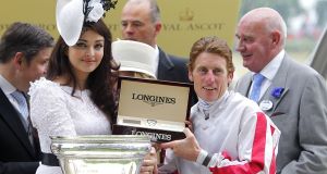 Bollywood superstar Aishwarya Rai Bachchan presents the King's Stand Stakes trophy to jockey Johnny Murtagh. Picture: Johnny Murtagh