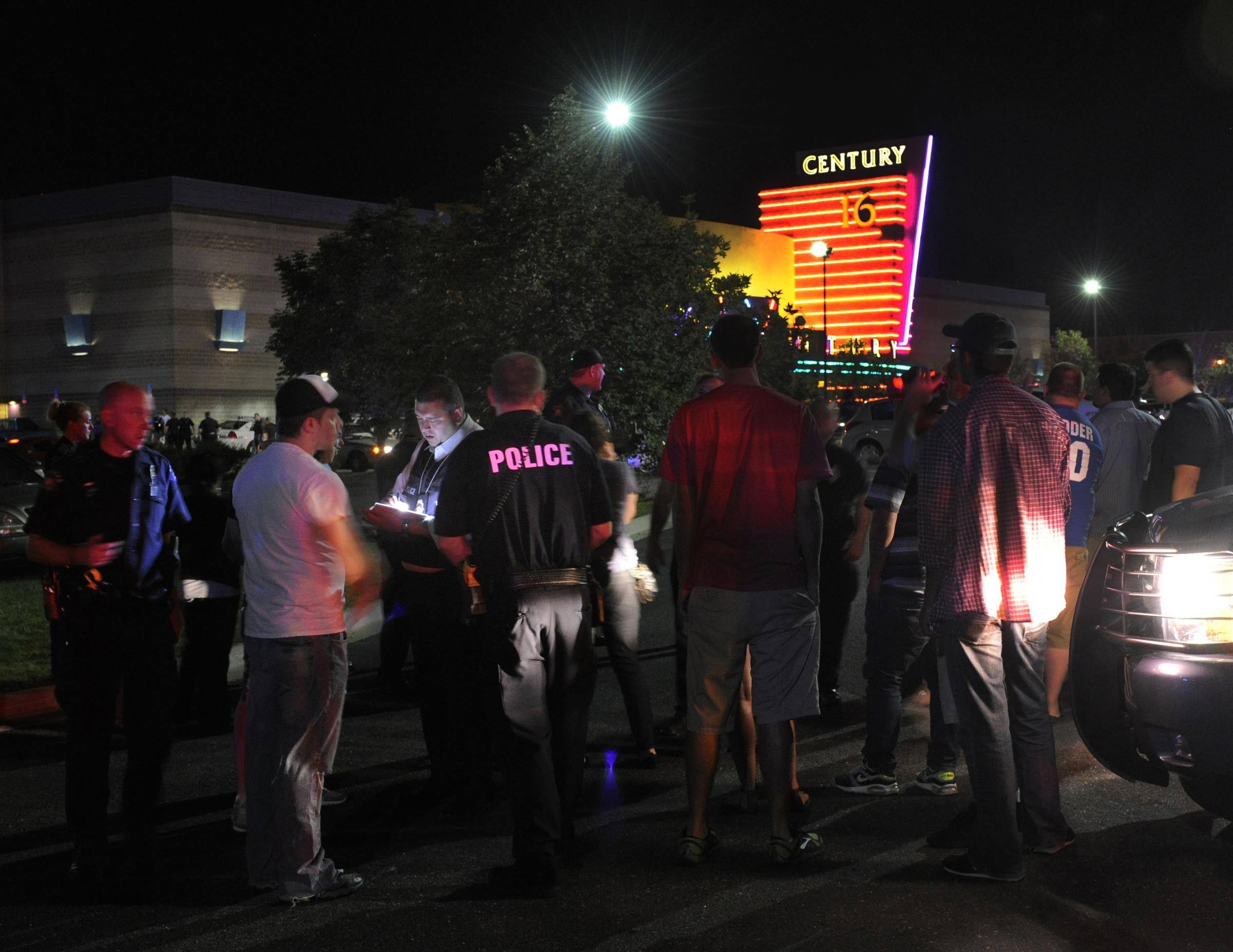 Police officers take witness statements outside a move theatre in Aurora, Colorado following an early morning shooting. Aurora Police responded to the Century 16 movie theatre early Friday morning. Pictures: AP