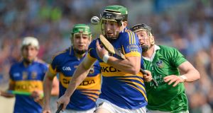 STOP ME IF YOU CAN: Tipperary's Kevin Downes evades the tackle of Limerick's Wayne McNamara in the 2012 Munster SHC quarter-final at Semple Stadium. Picture: Barry Cregg/Sportsfile