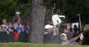 Tiger Woods hits out of a bunker on the second during the first round of the U.S. Open at Merion. (AP Photo/Darron Cummings)