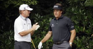 Steve Stricker, left, and Phil Mickelson talk before teeing off on the 11th hole at Merion on Thursday. Picture: AP Photo/Morry Gash