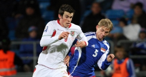 Gareth Bale tussels with Liechtensteins Martin Rechsteiner during their Qualifying match at the Rheinpark Stadion, Vaduz, Liechtenstein.
