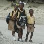 Children walk past collapsed buildings in Port-au-Prince, Haiti, which is struggling to rebuild itself after the earthquake two years ago.