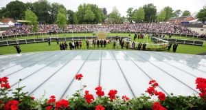 Britain's Queen Elizabeth II and the Duke and Duchess of Cornwall observe a minute's silence for the late Sir Henry Cecil during day one of Royal Ascot. Picture: PA