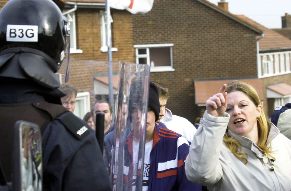 An unidetified woman shouts at police in the Ardoyne as children are escorted from Holy Cross school. Picture: AP