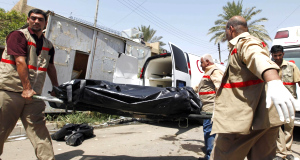 Paramedics carry a body on a stretcher outside the offices of the Al-Arabiya television station after today