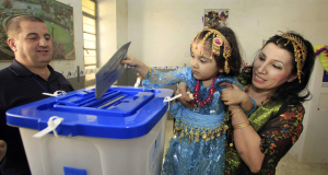 A Kurdish woman lets her daughter place her vote in the ballot box, at a polling station in Sulaimaniyah, Iraq. A Kurdish woman lets her daughter place her vote in the ballot box, at a polling station in Sulaimaniyah, Iraq.
