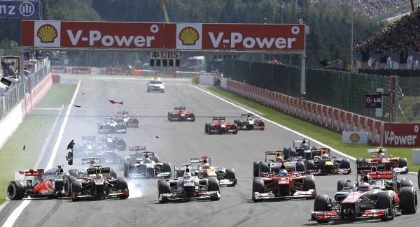 Jenson Button of Britain leads the field from the start, as McLaren Mercedes driver Lewis Hamilton of Britain rashes with Lotus driver Romain Grosjean of France, during the Belgian GP today.