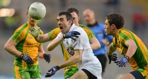 OUTNUMBERED: Kildare's John Doyle tries to find a way past Donegal's Martin McElhinney and Declan Walsh. Picture: Barry Cregg/Sportsfile 