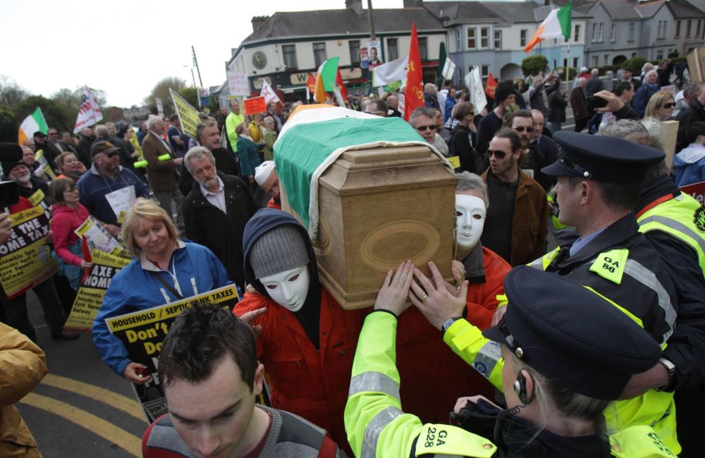 Anti-austerity protesters carry a coffin draped in the Irish flag at the Labour Party conference at NUI Galway today. Pictures: PA
