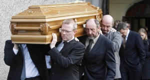 The coffin of Liam Clancy is carried from St Mary