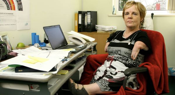 Irish Thalidomide Association chairwoman Maggie Woods at her desk. 'I am still here fighting for justice,' she says