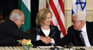 Secretary of State Hillary Rodham Clinton looks on as Palestinian President Mahmoud Abbas, right, and Israeli Prime Minister Benjamin Netanyahu shake hands as she hosts the re-launch of direct negotiations.