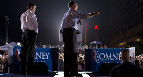 Mitt Romney speaks as vice presidential running mate Paul Ryan looks on during a campaign rally in Florida yesterday. Picture: AP