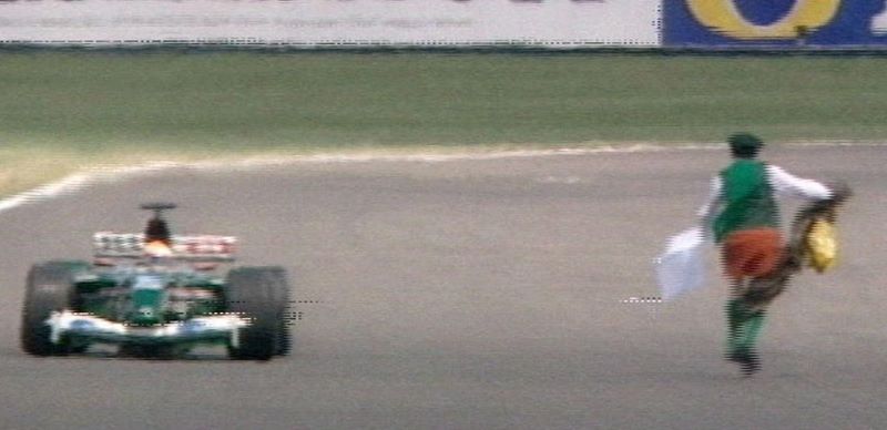 Cleric Neil Horan runs onto the track at the British Grand Prix at Silverstone.