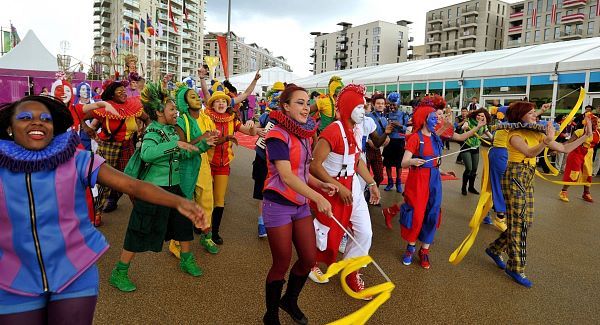 Members of the National Youth Theatre of Britain welcome athletes.