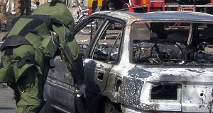 A Pakistani security officer visits the site of today