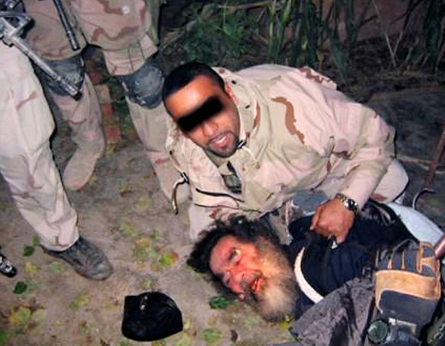 This picture allegedly shows US troops dragging Saddam from a hole at a farm in the village of ad-Dawr, near his hometown of Tikrit in northern Iraq.