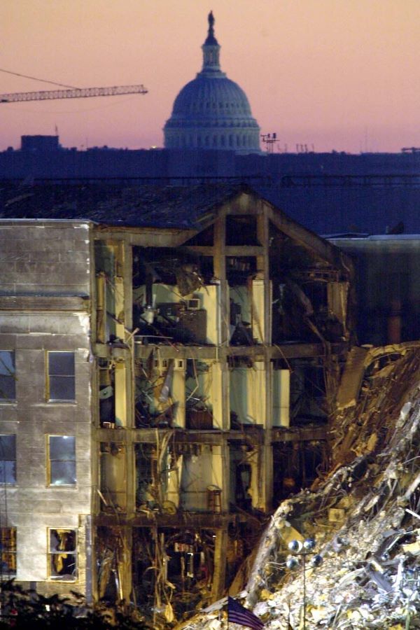 The dome of the Capitol building in Washington is visible behind the crash site at the Pentagon at sunrise on Sunday September 16.