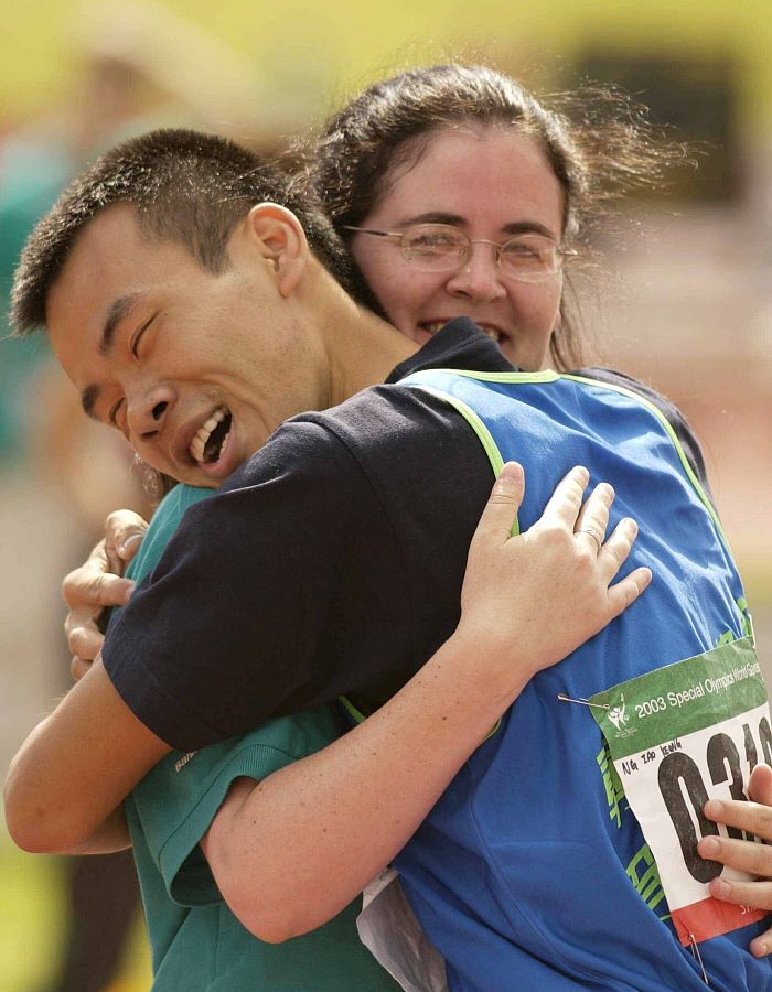 Ng Lao Keong, from Macau, celebrates his gold in a 200 mtrs race with volunteer Niamh McNamara, from Birr, Co Offaly at the 2003 World Special Olympics Games. Picture: Ray McManus / Sportsfile