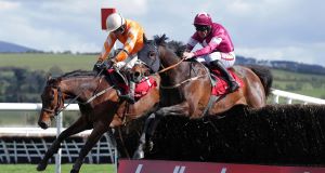Twinlight ridden by Ruby Walsh (left) jumps ahead of Far Away So Close ridden by Davy Russell to win the second race of the day yesterday. Picture: INPHO/Donall Farmer