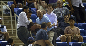 A fight between tennis fans breaks out in the stands and interrupts play between Serbia