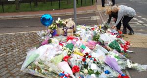 Women lay flowers outside the Royal Artillery Barracks in Woolwich. Picture: Max Nash/PA Wire
