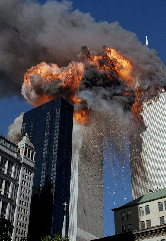 Smoke, flames and debris erupts from the second World Trade Centre towers as the plane strikes it. Picture: Chao Soi Cheong/AP